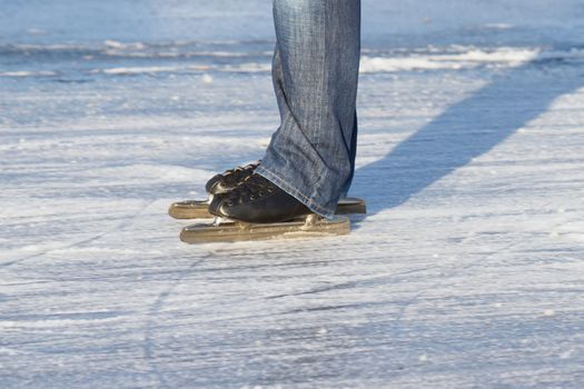 A ice skater is skating on the famous dutch Bonkevaart Friese Elfstedentocht