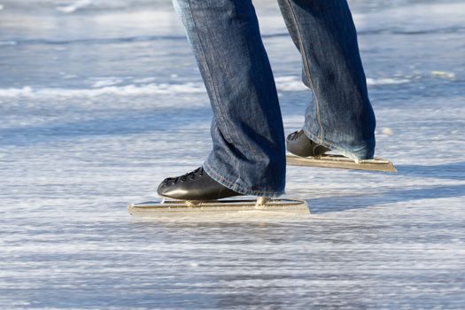 A ice skater is skating on the famous dutch Bonkevaart Friese Elfstedentocht