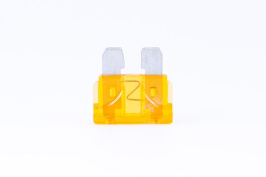 An orange car fuse with a white background