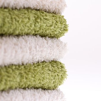 A pile of green and white towels