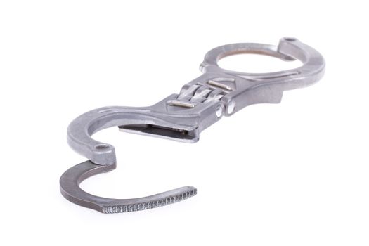 A close-up of metal handcuffs isolated on a white background