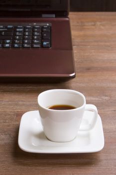 Espresso coffee on wood floor with laptop