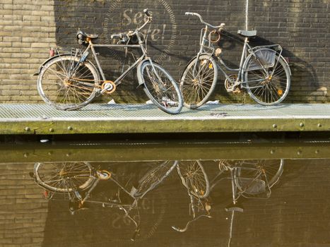 Two rusted bicycles are pulled out of the water