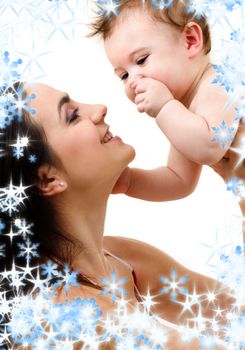 picture of happy mother with baby and snowflakes (focus on baby)