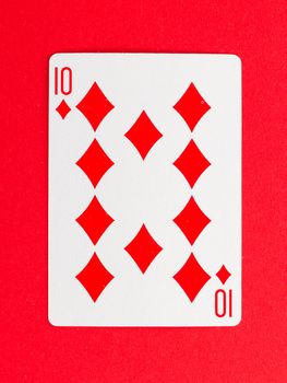 Old playing card (ten) isolated on a red background