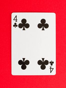 Old playing card (four) isolated on a red background