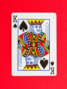 Old playing card (king) isolated on a red background