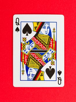 Old playing card (queen) isolated on a red background