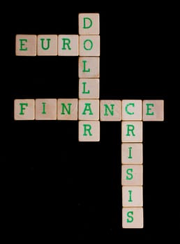 Green letters on old wooden blocks (euro, dollar, finance, crisis)