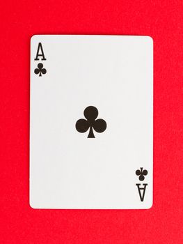 Old playing card (ace) isolated on a red background