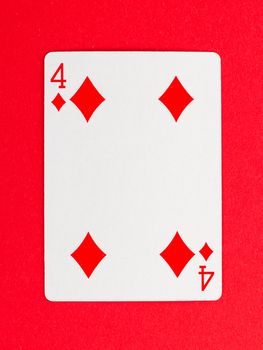 Old playing card (four) isolated on a red background