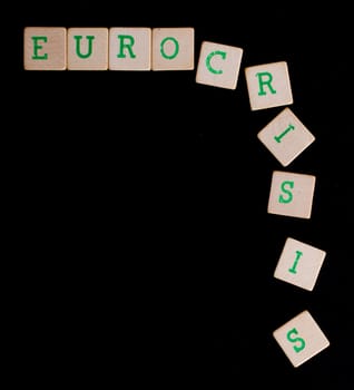 Green letters on old wooden blocks (eurocrisis)
