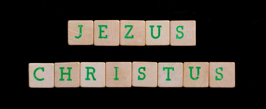 Green letters on old wooden blocks (Jezus Christus)