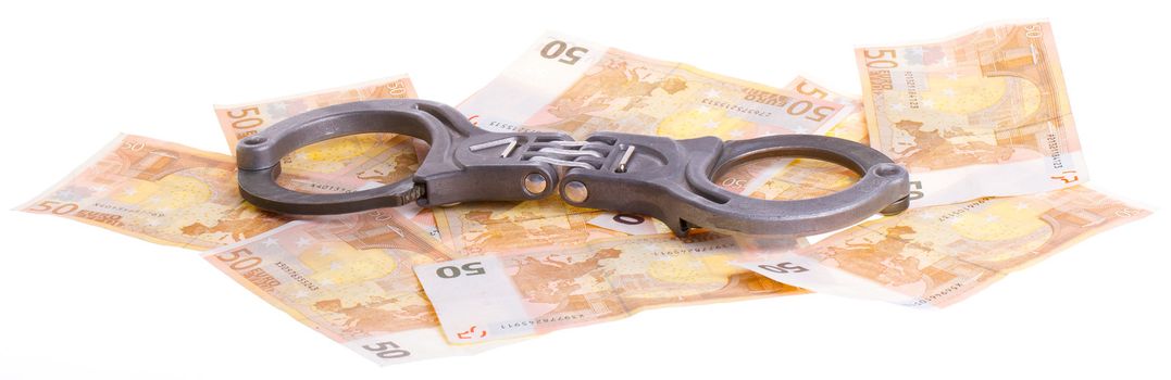 Handcuffs on 50 euro banknotes, isolated on a white background