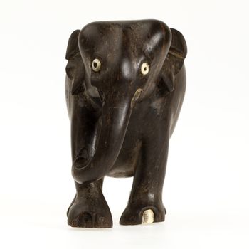 Very old ivory statue of an elephant isolated on a white beckground