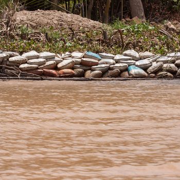 Dike made from sandbags erected to prevent the Mekong Delta from flooding one of the islands