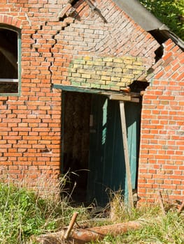 Broken doorway in an old brick wall