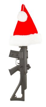 Weapon (firearm) concealed in santas hat, isolated on canvas