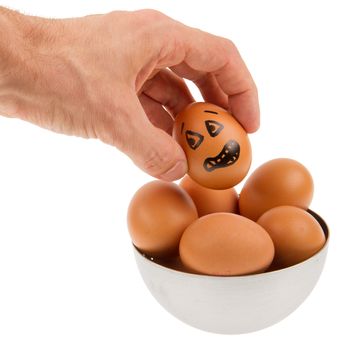 Scared egg, waiting to be grabbed by a hand, isolated