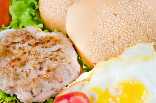 fried eggs, fresh vegetable , bread and fried pork