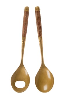 Old brass serving spoons isolated on a white background