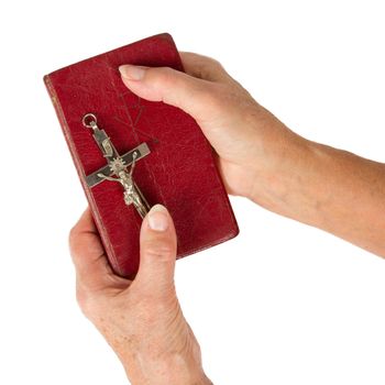 Old hands (woman) holding a very old bible, isolated on white