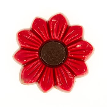 Damaged red chocolate flower, isolated on a white background