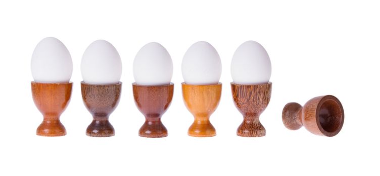 Set of different wooden egg cups isolated on white