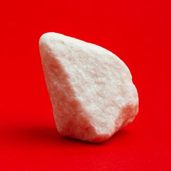 Glittering white stone isolated on a red background