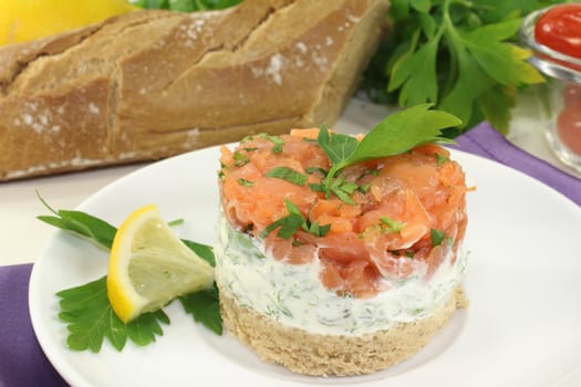 a slice of bread with herb cream and salmon tartare