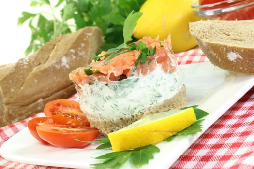 a slice of bread with herb cream and salmon tartare