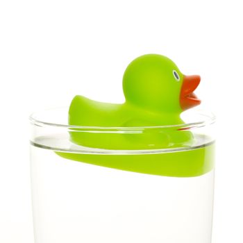 Green duck in a glass of water