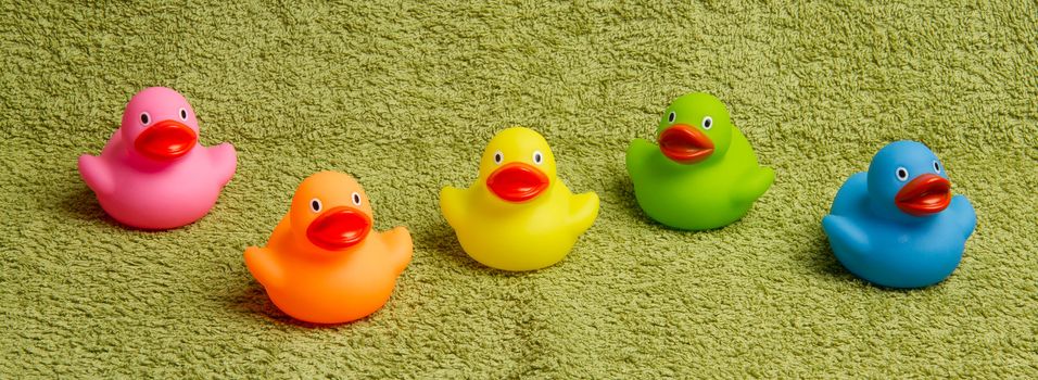 Rubber ducks isolated on a green towel