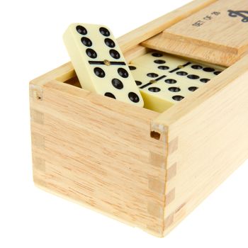 Domino in wooden box against the white background