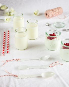 White and bright breakfast table with yogurt and berries