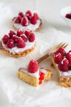 Raspberry frangipane tarts with icing drizzled over the top87