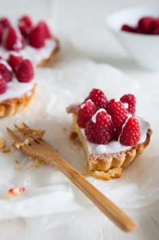 Raspberry frangipane tarts with icing drizzled over the top
