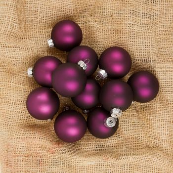 Purple Christmas balls isolated on canvas