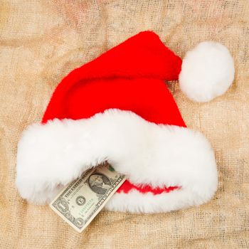 Santa's crisis budget, one dollar in his hat