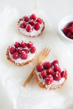 raspberry frangipane tarts with icing drizzled over the top