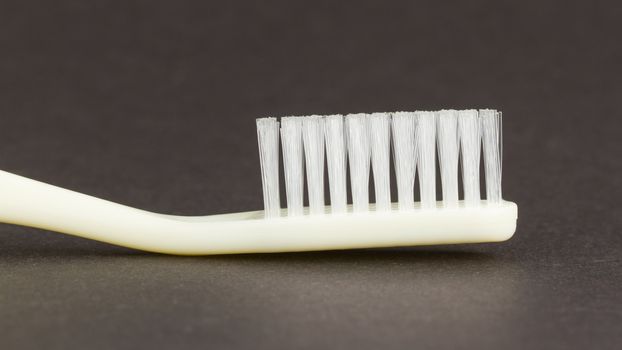 White toothbrush isolated on a black background