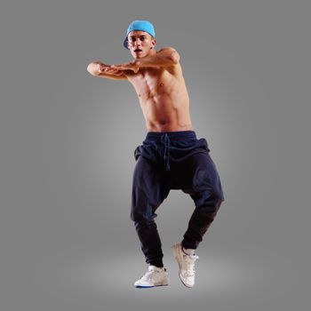 dancer of hip-hop on a gray background , motion