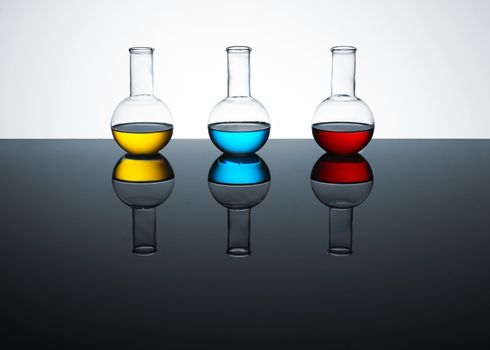 laboratory test tubes with colored liquid, place for text