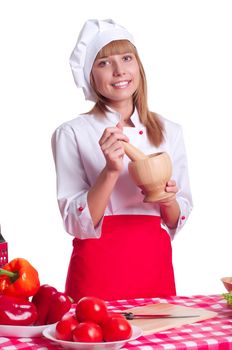 attractive cook chef costume preparing the spices in a mortar