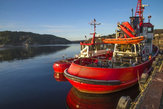 tug frier & tug evis is moored to the quay at the port of halden, image is shot in december 2012.