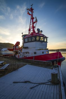 tug frier is moored to the quay at the port of halden, image is shot in december 2012.