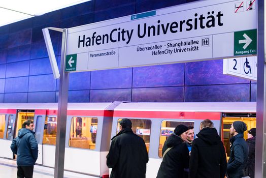 HAMBURG - DECEMBER 2, 2012: First passengers are using the new underground station “Hafencity University” in Hamburg Hafencity on December 2, 2012 in Hamburg Germany. The station connects the exciting newly built area of Hafencity with the rest of Hamburg – currently the public can test drive the line for free before the station is officially connected with the timetable of the underground.