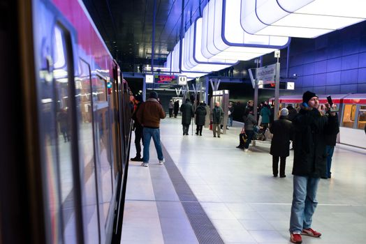 HAMBURG - DECEMBER 2, 2012: First passengers are using the new underground station “Hafencity University” in Hamburg Hafencity on December 2, 2012 in Hamburg Germany. The station connects the exciting newly built area of Hafencity with the rest of Hamburg – currently the public can test drive the line for free before the station is officially connected with the timetable of the underground.