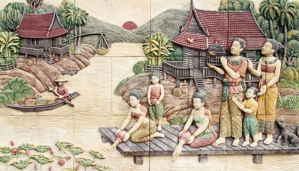 Thai culture stone carving on temple wall