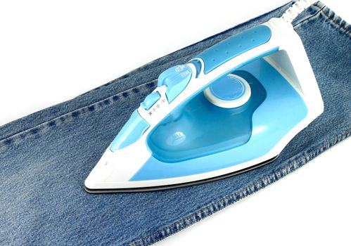 Ironing jeans on a white baclground